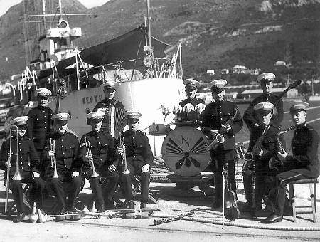 The Royal Marine band on the jetty by the stern of HMS Neptune at Simon's Town in July 1941